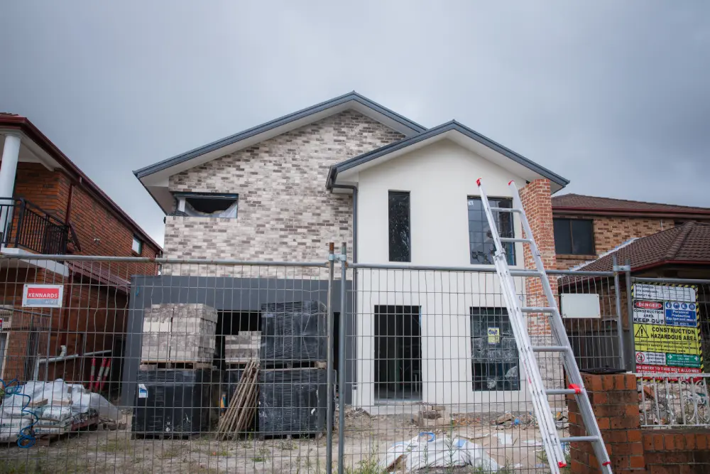 Modern front fence with timber slats and landscaping on an Australian suburban home