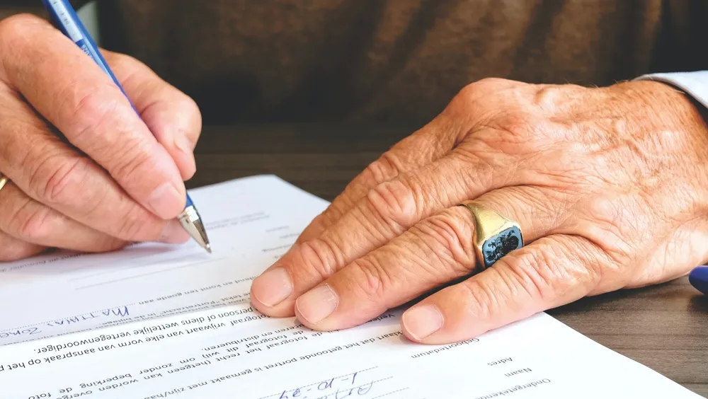 Australian homeowner and builder reviewing a construction contract at a building site